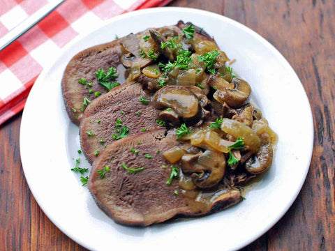 Boiling and cooking veal tongue with mushrooms
